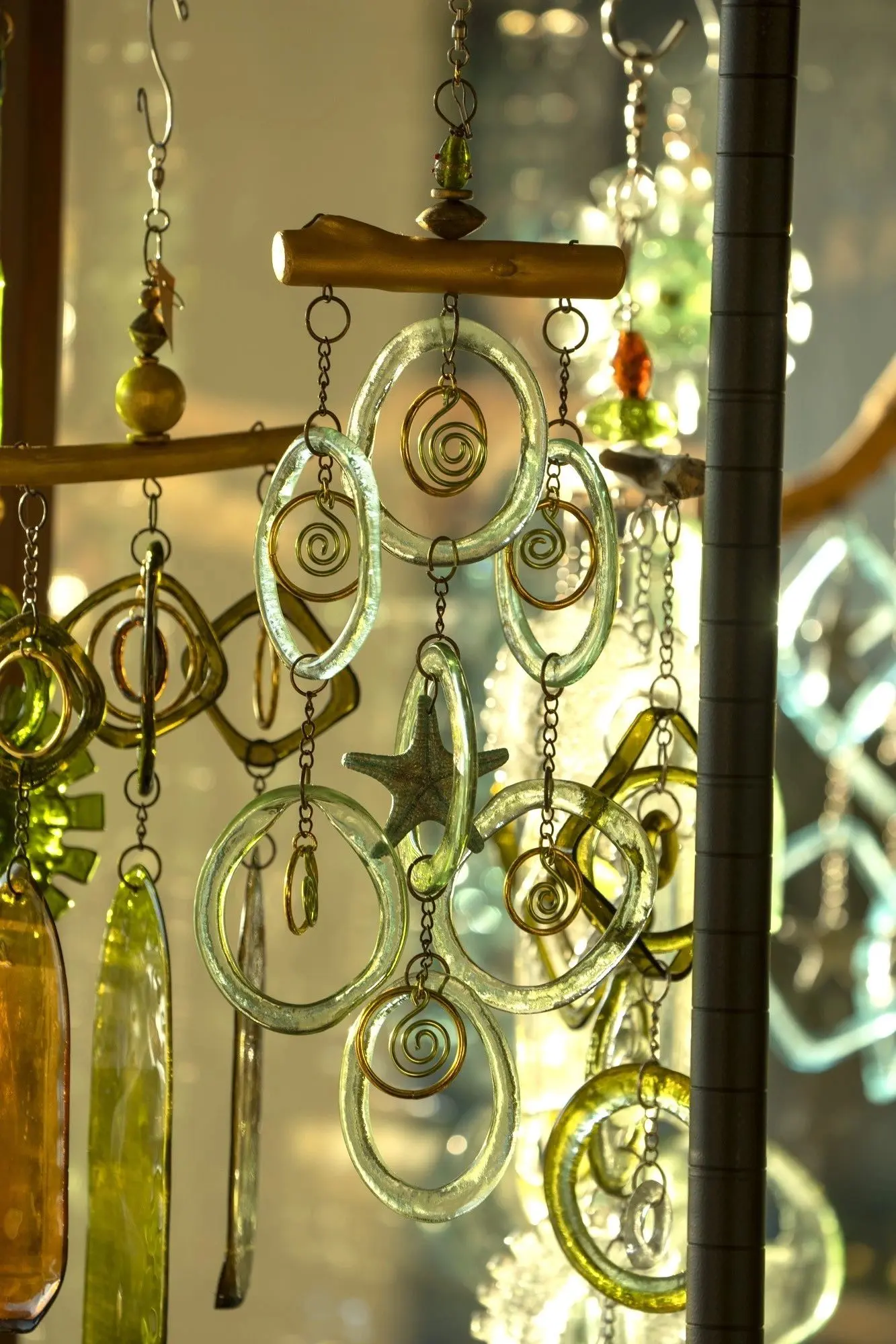 Glass wind chimes with swirling designs hanging.