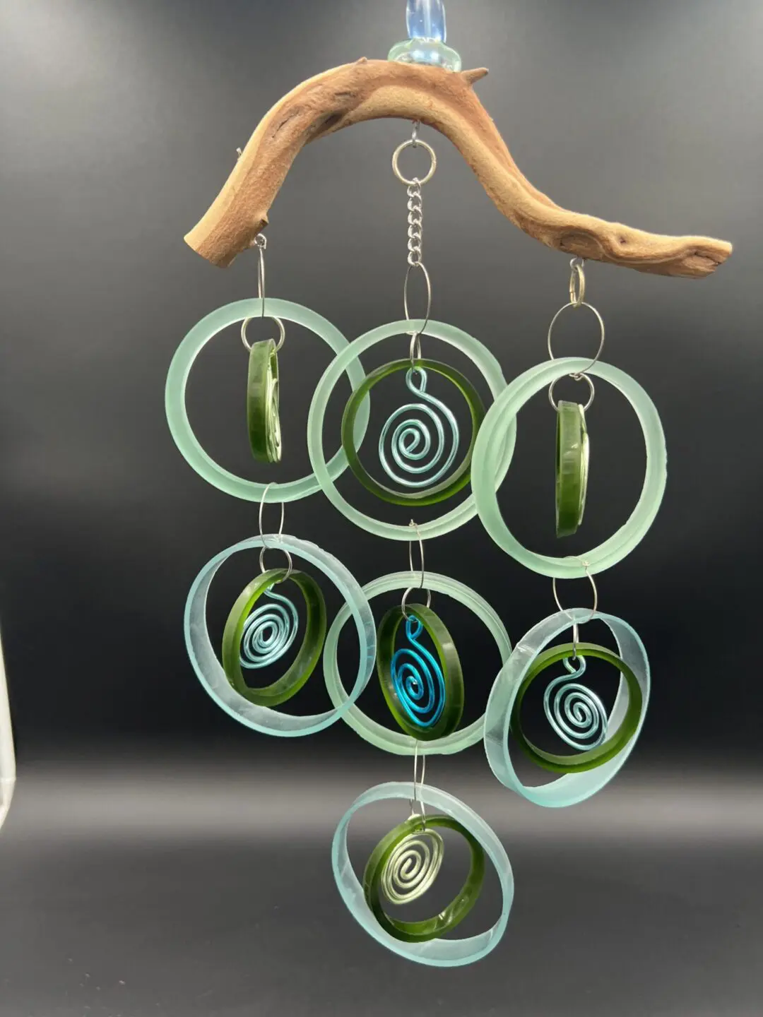 Glass spiral wind chime with wooden top.
