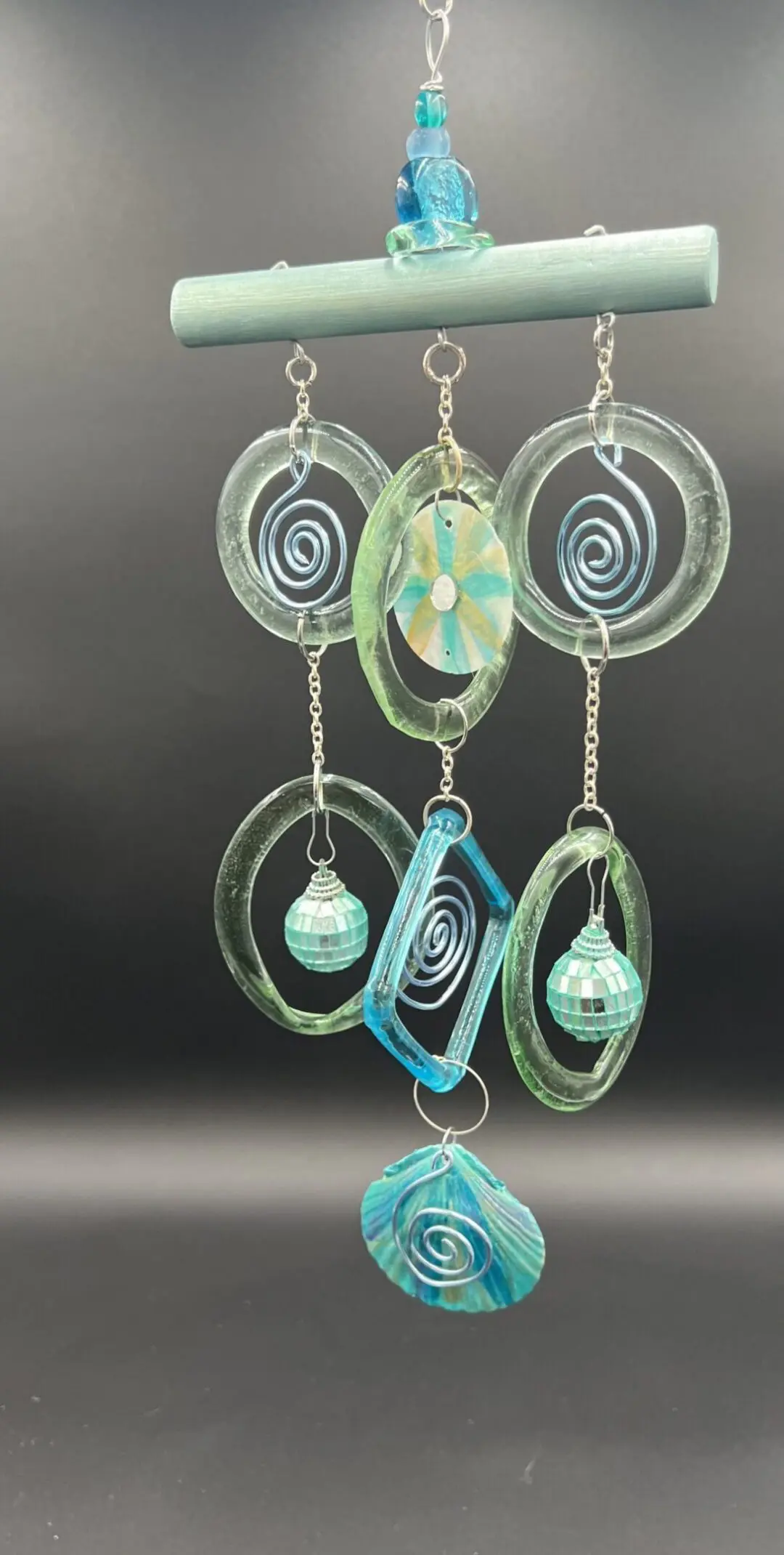 Glass wind chime with spiral designs.