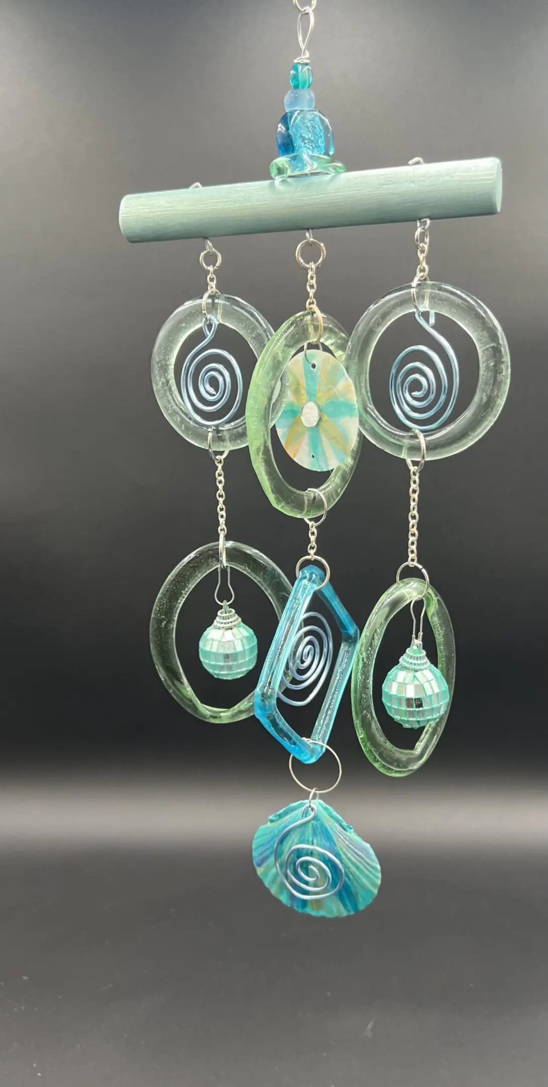 Glass wind chime with spiral designs.