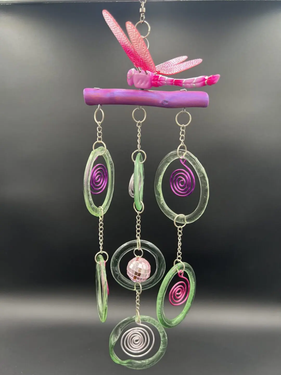 Colorful wind chime with dragonfly design.