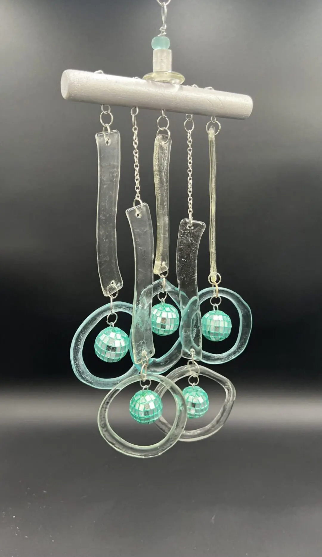 Glass wind chime with teal accents.
