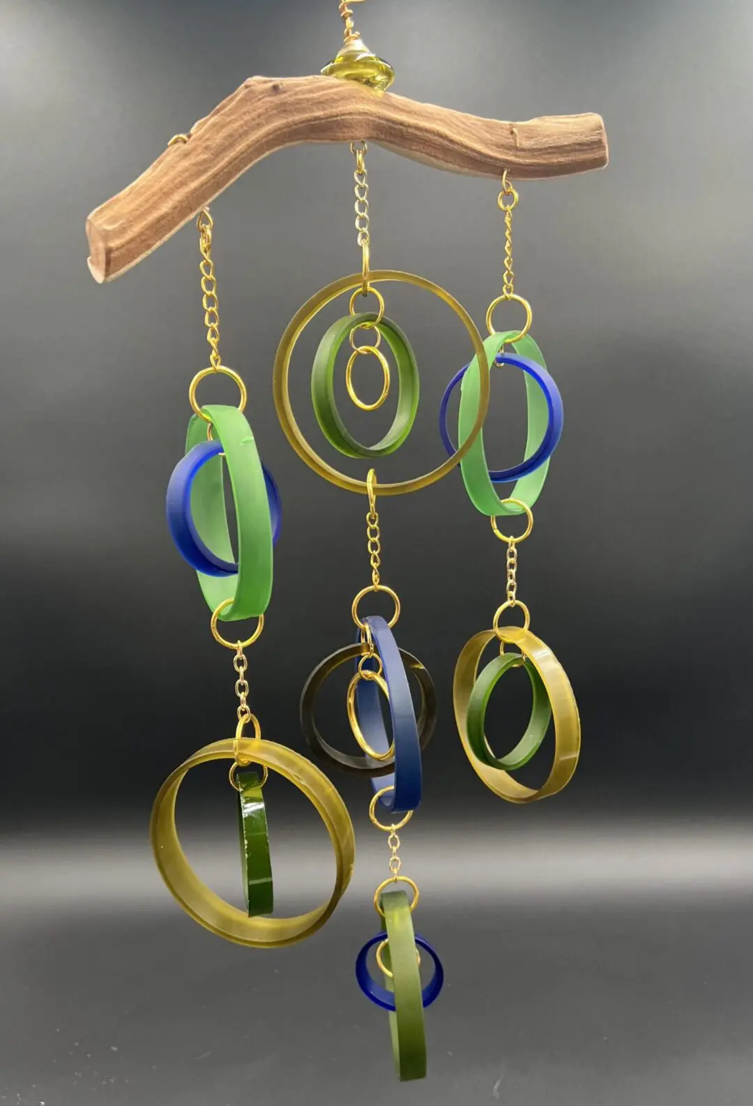 Colorful hanging mobile with circular shapes.
