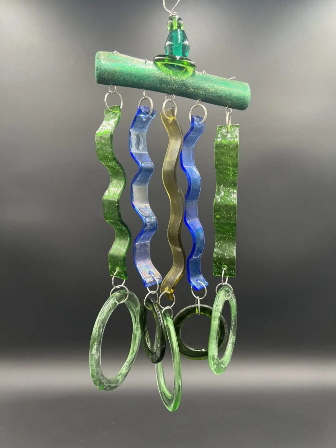Colorful wavy glass wind chime hanging.