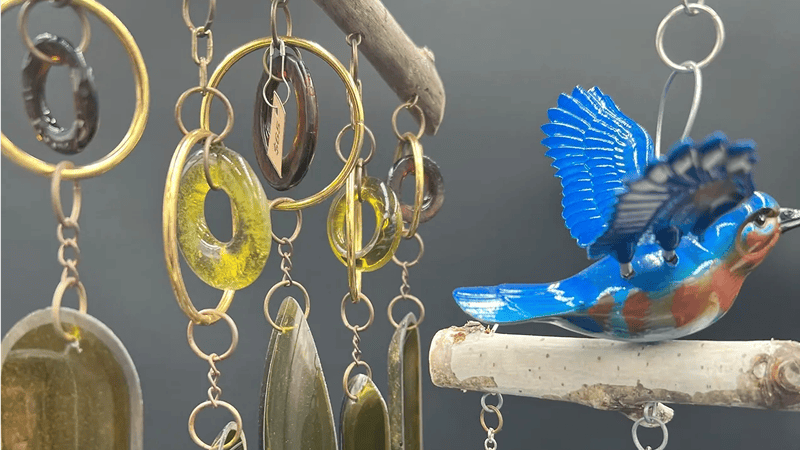 Colorful bird with decorative hanging ornaments.