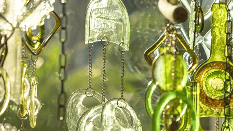 Hanging glass wind chimes with green accents.